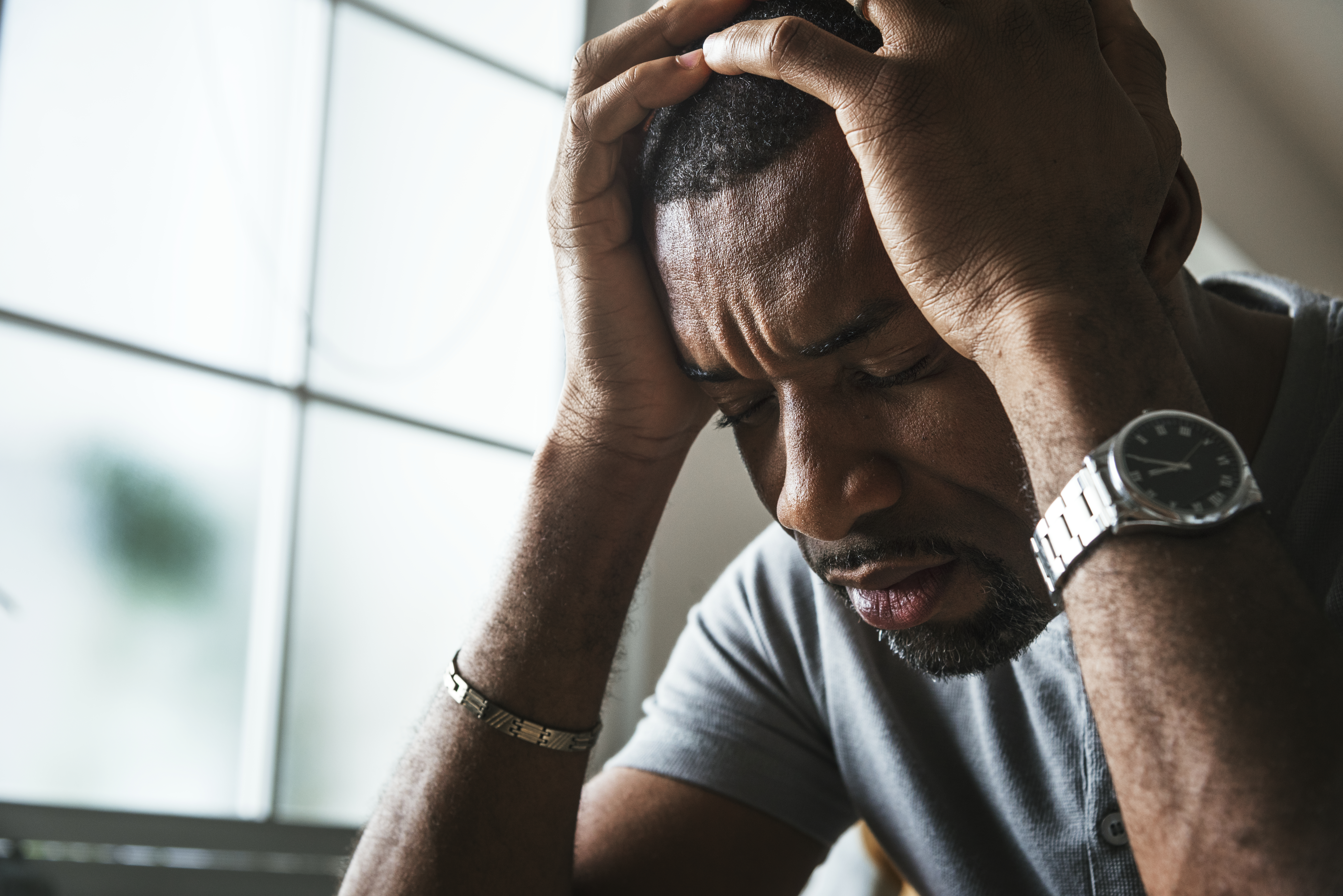 distressed man with head in hands