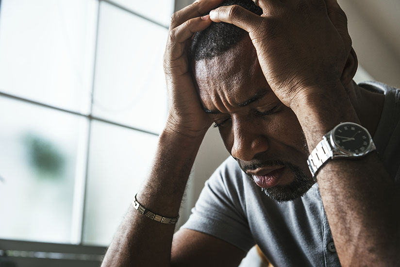 distressed man with head in hands